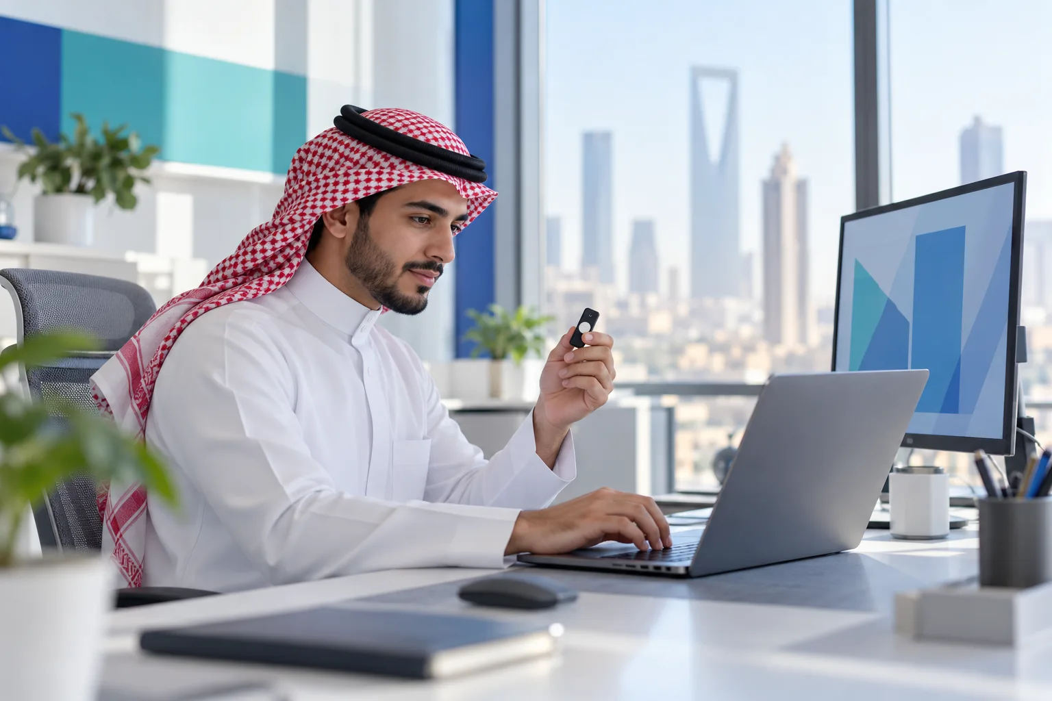 Saudi accountant onboarding an invoicing system to the Fatoora platform on a laptop
