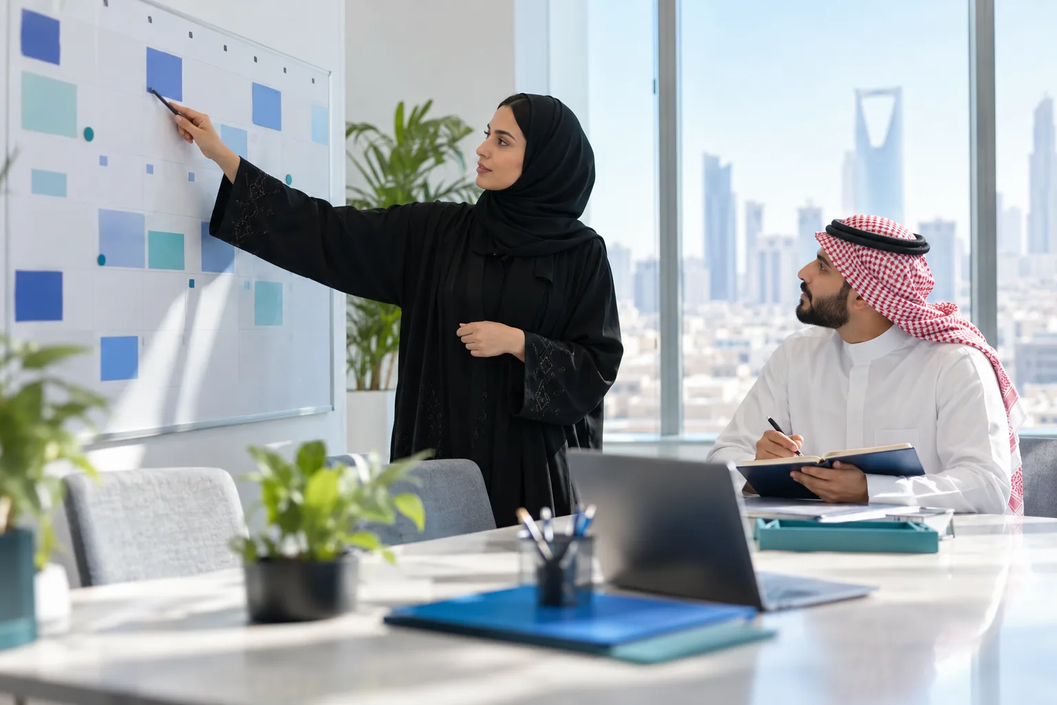 مدير مالي سعودي يراجع تقويم مواعيد الإقرارات الضريبية في مكتب مضيء